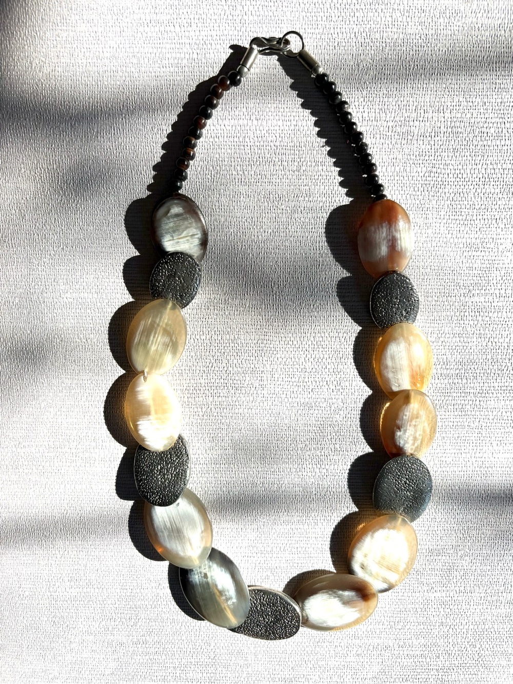 Polished Horn and hammered silver discs Handcrafted Necklace by jewelry artist